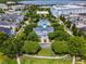 Aerial shot features community pool and clubhouse nestled among lush landscaping with lake in background at 4562 Lower Park Rd, Orlando, FL 32814
