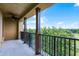 Relaxing outdoor balcony featuring black metal railings and offering scenic views of the surrounding lush landscape at 4562 Lower Park Rd, Orlando, FL 32814