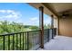 Spacious balcony features black metal railings and scenic views of surrounding trees and blue skies at 4562 Lower Park Rd, Orlando, FL 32814