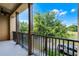 The balcony has brown pillars and black railings with expansive views of the neighborhood at 4562 Lower Park Rd, Orlando, FL 32814