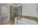 Modern bathroom featuring a soaking tub, glass enclosed shower and walk in closet at 4562 Lower Park Rd, Orlando, FL 32814