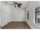 This room has vinyl floors, a ceiling fan and is bathed in light from the two windows at 4562 Lower Park Rd, Orlando, FL 32814