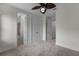 Bright bedroom with neutral carpeting, ceiling fan and easy access to an ensuite bathroom and closet space at 4562 Lower Park Rd, Orlando, FL 32814