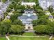 Aerial view of a stately building with manicured landscaping and mature trees at 4562 Lower Park Rd, Orlando, FL 32814
