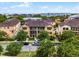View of the front of a tan condo building with balconies and lush green landscaping at 4562 Lower Park Rd, Orlando, FL 32814
