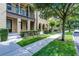 Inviting exterior view of a townhome featuring a manicured lawn, and sidewalk and traditional architectural details at 4562 Lower Park Rd, Orlando, FL 32814