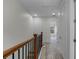 Bright hallway with carpet floors, white walls, and wooden railings, leading to various rooms and spaces at 4562 Lower Park Rd, Orlando, FL 32814