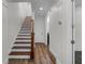Bright hallway featuring hardwood floors and a staircase leading to the upper level of the house at 4562 Lower Park Rd, Orlando, FL 32814