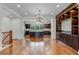 Open-concept kitchen with a large island, dark wood cabinetry, stainless steel appliances and hardwood floors at 4562 Lower Park Rd, Orlando, FL 32814