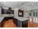 Modern kitchen featuring a large island with a wine cooler and view of the living room at 4562 Lower Park Rd, Orlando, FL 32814