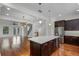 Contemporary kitchen featuring granite countertops, stainless steel appliances, and a large island with bar seating at 4562 Lower Park Rd, Orlando, FL 32814