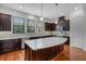 Modern kitchen with an island, stainless appliances, dark wood cabinets and quartz counters at 4562 Lower Park Rd, Orlando, FL 32814