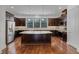 Spacious kitchen with a large island, dark cabinets, stainless steel appliances, and hardwood floors at 4562 Lower Park Rd, Orlando, FL 32814