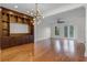 Spacious living room features hardwood floors, a modern chandelier, and a built-in entertainment center at 4562 Lower Park Rd, Orlando, FL 32814