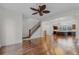 Spacious living room with hardwood floors, staircase and open kitchen perfect for entertaining and relaxation at 4562 Lower Park Rd, Orlando, FL 32814