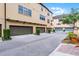 View of townhomes and garages featuring neat landscaping along a paved street in a residential area at 4562 Lower Park Rd, Orlando, FL 32814