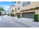 Street view of townhomes featuring attached garages and manicured landscaping in a well-maintained community at 4562 Lower Park Rd, Orlando, FL 32814