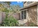 View of the side patio with sliding glass door, a wood fence and landscaping at 503 Portland Cir, Apopka, FL 32703