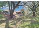 Spacious backyard with a patio, mature trees, and lush lawn, perfect for outdoor entertaining and relaxing at 503 Portland Cir, Apopka, FL 32703