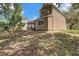 Backyard view of two-story home with patio and well-maintained lawn, perfect for outdoor activities at 503 Portland Cir, Apopka, FL 32703