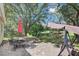 Lush backyard featuring a patio with outdoor dining, a swing, and views of a tranquil pond at 503 Portland Cir, Apopka, FL 32703