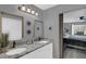 Bathroom featuring double sinks, granite countertops, barn-door to bedroom and modern fixtures at 503 Portland Cir, Apopka, FL 32703