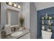 Bathroom features a granite countertop vanity with decorative shelf over a toilet at 503 Portland Cir, Apopka, FL 32703