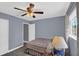 Bedroom with a wooden fan and a window with curtains at 503 Portland Cir, Apopka, FL 32703