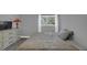 Comfortable gray bedroom with dresser, lamps, window with curtains, and a queen bed at 503 Portland Cir, Apopka, FL 32703