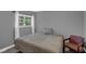 Neutral bedroom with a queen bed, large window with natural light, and chair at 503 Portland Cir, Apopka, FL 32703