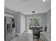 Bright breakfast nook features a sliding door to the backyard and stainless steel refrigerator at 503 Portland Cir, Apopka, FL 32703