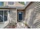 Home entrance with a stylish front door, exterior lighting and landscaping near the front door at 503 Portland Cir, Apopka, FL 32703