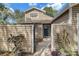 Inviting home entrance surrounded by decorative wooden fence, a gate and landscaped walkway to the front door at 503 Portland Cir, Apopka, FL 32703
