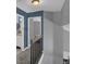 Upstairs hallway with wood railing, gray carpet, with views into a bedroom and bathroom at 503 Portland Cir, Apopka, FL 32703