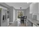 The kitchen features an adjacent table, stainless steel refrigerator, and lots of natural light at 503 Portland Cir, Apopka, FL 32703