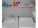 Laundry room shows a washer, dryer and wire rack shelving for storage at 503 Portland Cir, Apopka, FL 32703