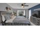 Well-lit main bedroom with gray walls, ceiling fan, a large window, and ample closet space at 503 Portland Cir, Apopka, FL 32703
