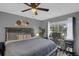 Main bedroom with light gray walls, ceiling fan, a large window, and desk area at 503 Portland Cir, Apopka, FL 32703