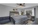 Relaxing main bedroom with a large window, ceiling fan, and cozy decor at 503 Portland Cir, Apopka, FL 32703