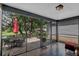 Enjoy outdoor living on this screened-in patio overlooking a serene backyard oasis with seating and mature trees at 503 Portland Cir, Apopka, FL 32703
