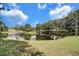 Beautiful pond view with fountain, surrounded by green lawn and trees, creating a peaceful outdoor space at 503 Portland Cir, Apopka, FL 32703
