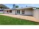 This home features a brick patio and a well-maintained lawn at 5130 Sun Palm Dr, Windermere, FL 34786