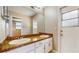 Bathroom featuring double sinks, granite countertops, white cabinets, and tile floors at 5130 Sun Palm Dr, Windermere, FL 34786