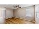 Bedroom with a ceiling fan, wood floors and a window with natural light at 5130 Sun Palm Dr, Windermere, FL 34786