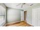 Neutral bedroom with stylish wood-look floors, ceiling fan, and closet for plenty of storage at 5130 Sun Palm Dr, Windermere, FL 34786
