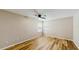 Bright bedroom with wood floors, ceiling fan, and natural light from dual windows at 5130 Sun Palm Dr, Windermere, FL 34786