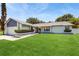 Well-maintained home showcasing a lush green lawn and tidy landscaping at 5130 Sun Palm Dr, Windermere, FL 34786