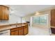 Kitchen featuring a stainless steel sink, wood cabinetry, and granite countertops at 5130 Sun Palm Dr, Windermere, FL 34786