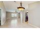 Spacious living room showcasing tile floors, neutral paint, decorative lighting, and kitchen view at 5130 Sun Palm Dr, Windermere, FL 34786