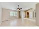 Bright living room with neutral walls, tile flooring, and a view of the laundry room at 5130 Sun Palm Dr, Windermere, FL 34786